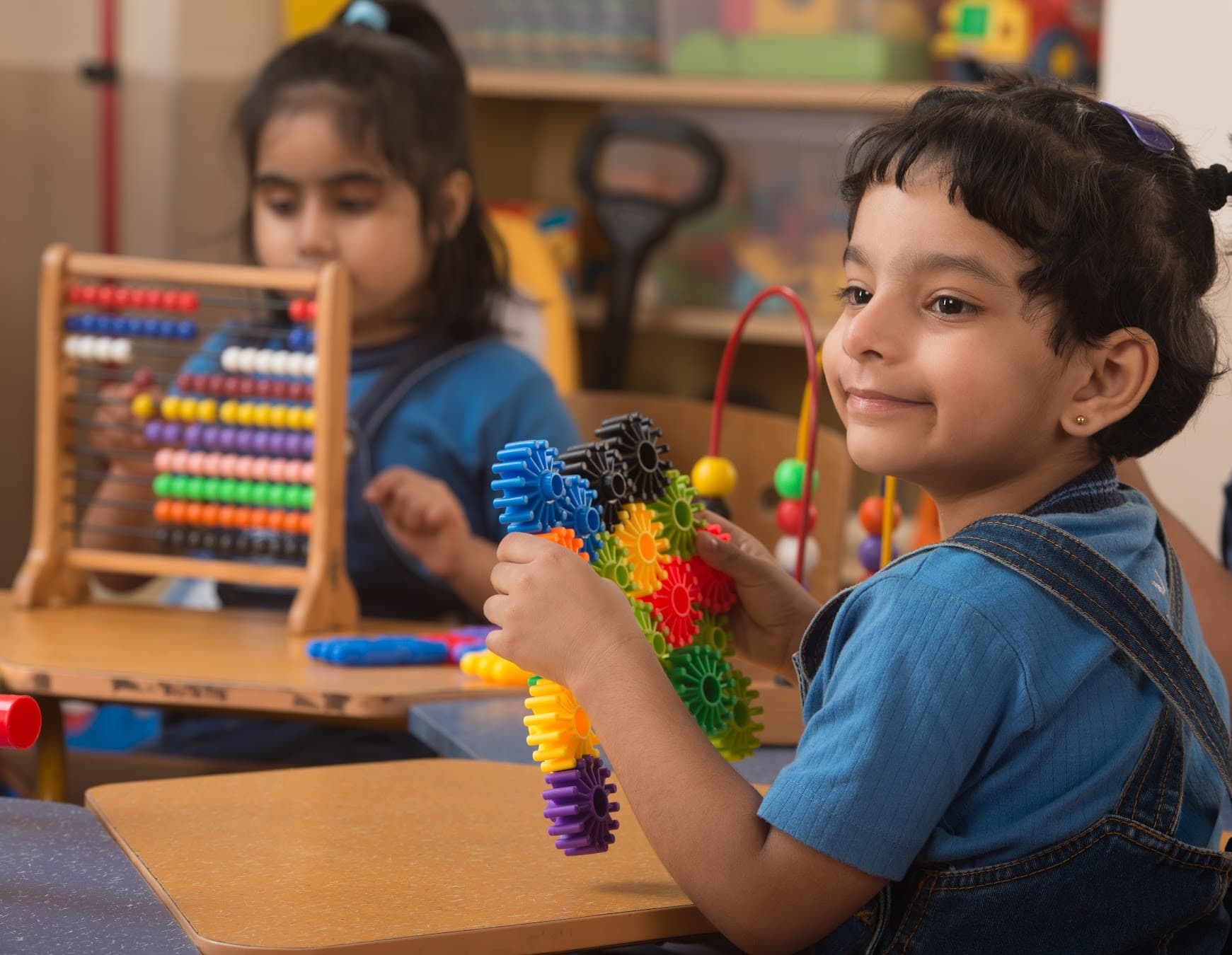 Children discovering hands-on learning with colourful construction toys