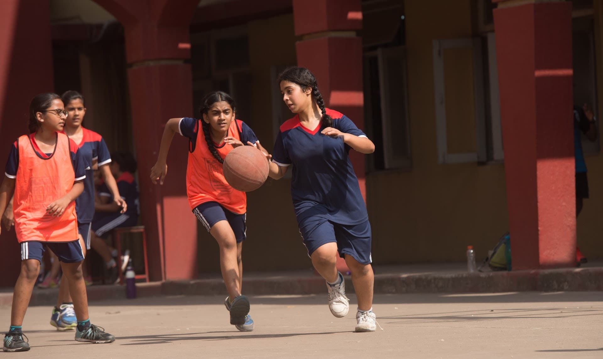 Older students building teamwork through basketball